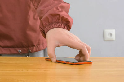 Midsection of woman on table at home