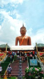 Low angle view of statue against temple against sky