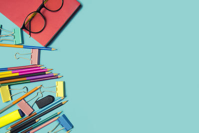 Close-up of books on table against blue background