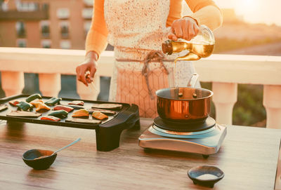 Woman preparing food on table at home