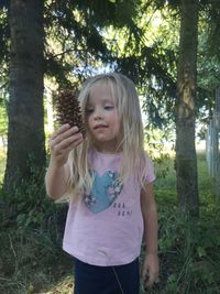 Portrait of cute girl standing in forest