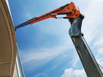 Low angle view of crane against sky