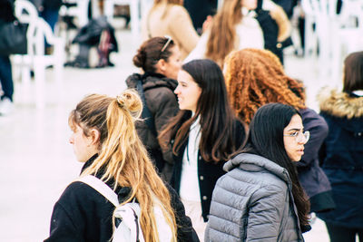 Woman standing with people in background