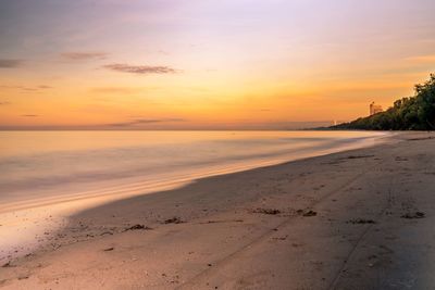 Scenic view of beach against sky during sunset