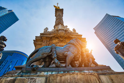 Low angle view of statue of historic building against sky