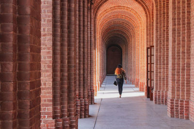 Full length rear view of woman in building