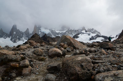 Scenic view of mountains against cloudy sky