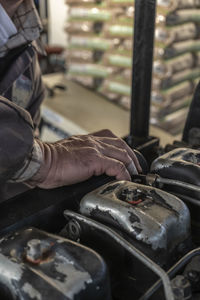 Close-up of man working at sunset