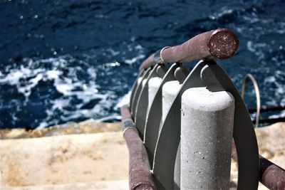Close-up of coin-operated binoculars by sea