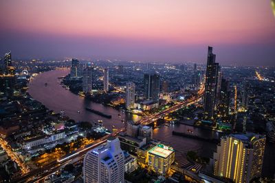 Aerial view of city lit up at night