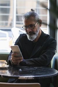 Portrait of man sitting on table