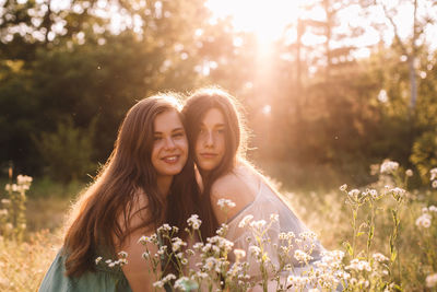 Portrait of smiling young woman against plants