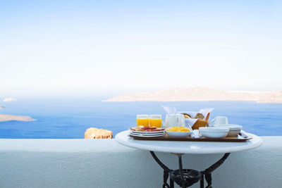 View of breakfast on table by sea against sky