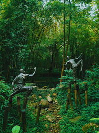 View of statue amidst trees in forest