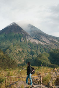 Full length of man riding on mountain against sky