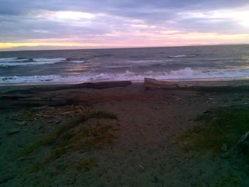 Scenic view of beach against dramatic sky