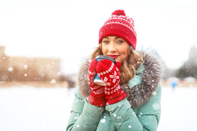 Portrait of a smiling woman in snow