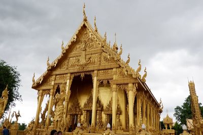 Low angle view of temple against cloudy sky