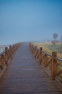 Wooden bridge engulfed in fog