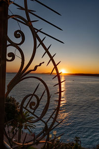 Scenic view of sea against orange sky