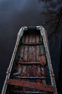 Low angle view of abandoned boat against lake