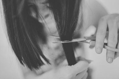 Close-up of woman cutting hair