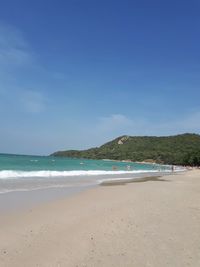 Scenic view of beach against blue sky