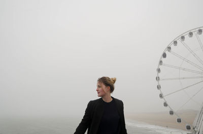Woman by beach in fog
