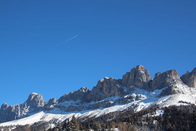Scenic view of snowcapped mountains against clear blue sky