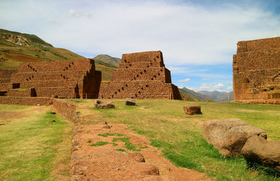 Old ruins on field against sky