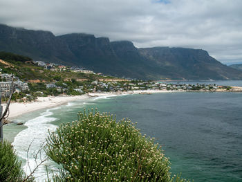Scenic view of sea and mountains against sky