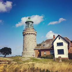 Low angle view of lighthouse on field against sky