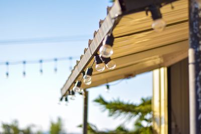 Low angle view of decoration hanging from roof against clear sky