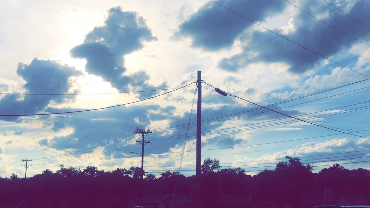 LOW ANGLE VIEW OF POWER LINES AGAINST CLOUDY SKY