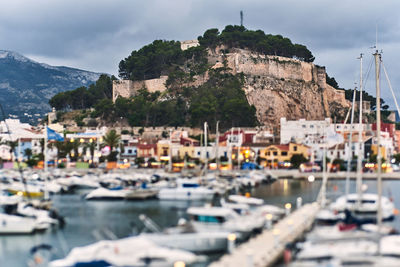 Scenic view of sea by buildings against sky