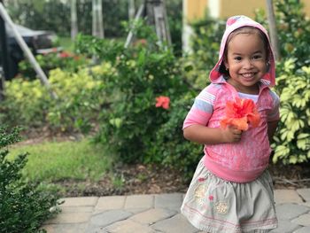 Portrait of smiling girl with flowers