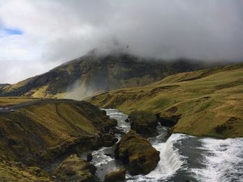 Scenic view of mountain against cloudy sky