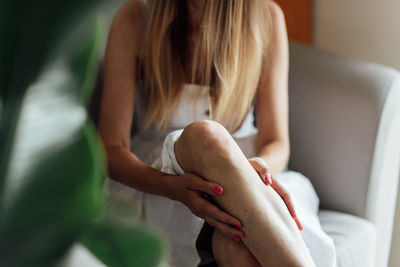 Midsection of woman holding book