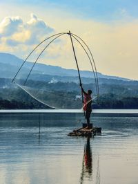 Rear view of man in boat in sea