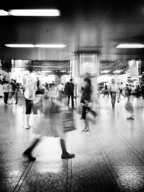 indoors, large group of people, men, person, lifestyles, illuminated, flooring, walking, tiled floor, leisure activity, city life, railroad station, built structure, full length, architecture, ceiling, subway station, lighting equipment, passenger