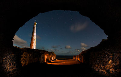 Panoramic view of illuminated built structure at night