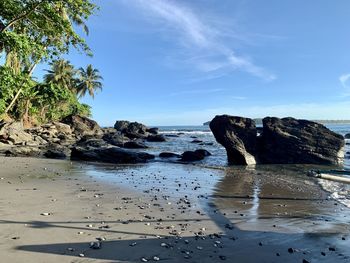 Rocks on beach against sky