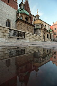 Reflection of wawel cathedral on puddle