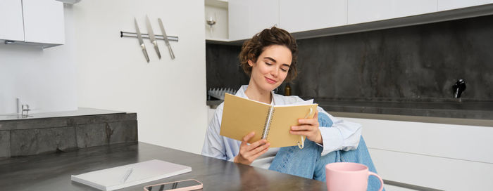 Portrait of young woman using mobile phone