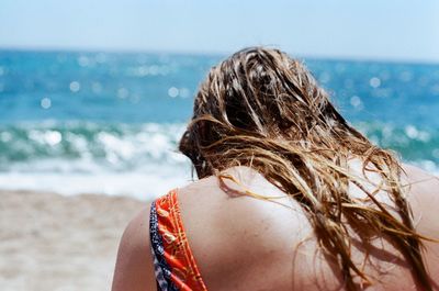 Portrait of woman on beach against sky