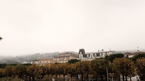 Buildings in city against clear sky