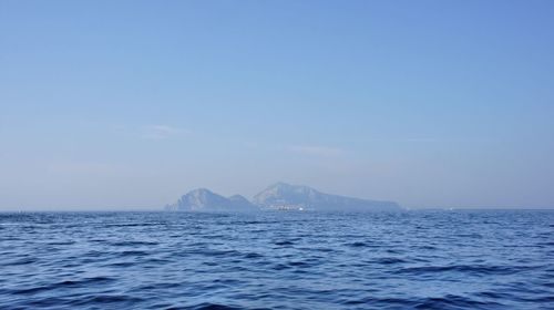 Scenic view of sea against clear blue sky
