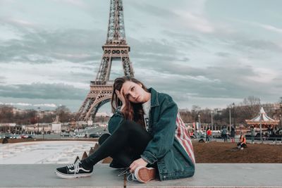 Full length of young woman with tower in background