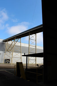 Low angle view of industrial building against sky