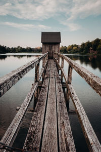 Pier over lake against sky